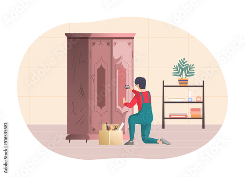 Male professional restore restoring old vintage wooden wardrobe. Craftsman repairing retro furniture and cleaning wood of closet with brush.