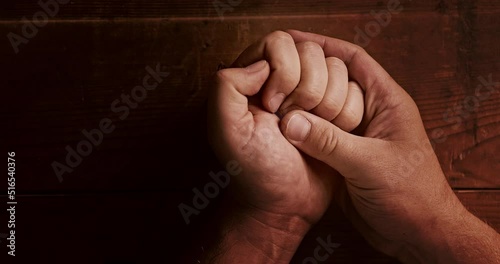 A Christian opens his palm with a cross