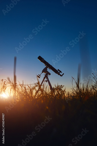 Astronomical telescope under a twilight sky ready for stargazing.