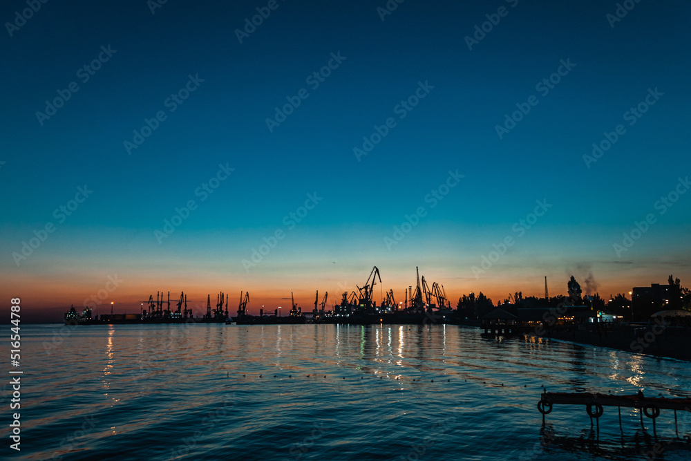 Twilight sea and small town`s silhouettes