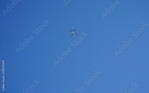 helicopter in flight with blue background.