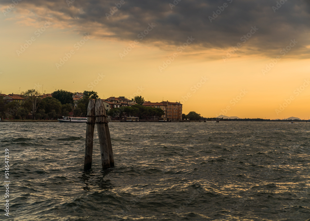 Beautiful Mediterranean sunset with clouds and the open lagoon in Venice, Italy 
