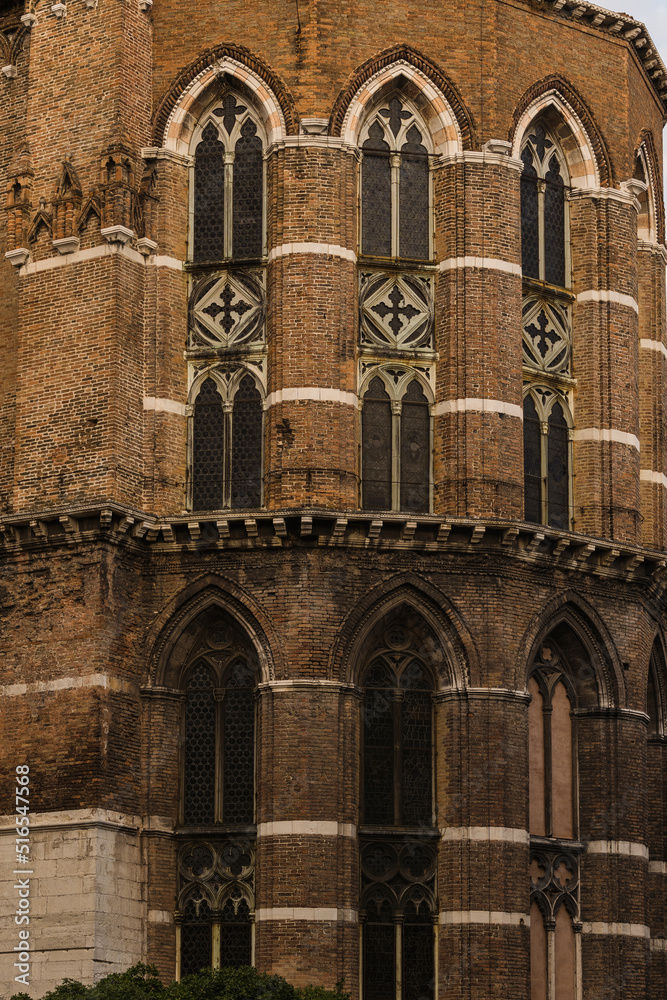 Architectural detail of an old church in Venice, Italy with detail of gothic windows 