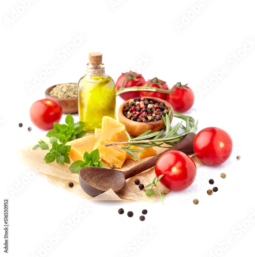 Fresh tomatoes with basil leaves, rosemary, pepper, olive oil and cheese isolated on white background. Ripe tomatoes with spices.