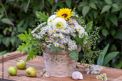 Blumenstrauß mit weißen Dahlien, Sonnenblume, Wildastern, Schafgarbe, Holunderbeeren uns Eichenblättern photo