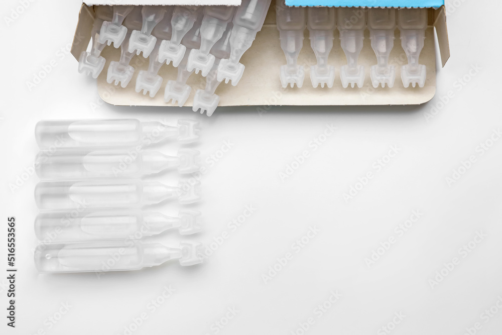 Single dose ampoules of sterile isotonic sea water solution on white background, top view Single dose ampoules of sterile isotonic sea water solution on white background, top view