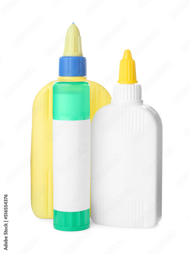 Different bottles and stick of glue on white background Different bottles and stick of glue on white background