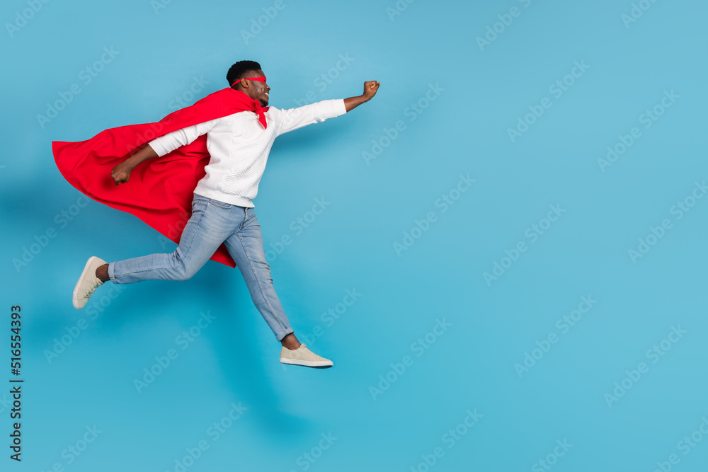 Full body profile photo of strong guy raise hand fly empty space isolated on blue color background