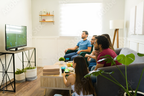 Sports fans watching the soccer championship on tv photo