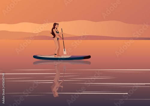 Woman on sup board at sunset