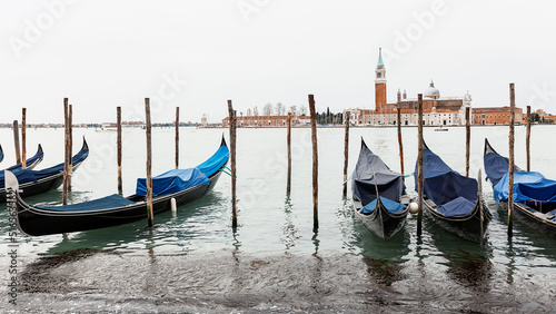 Gondolas are moored in Saint Mark's Square. Church of San Giorgio di Maggiore in the background .Venice, Italy, Europe