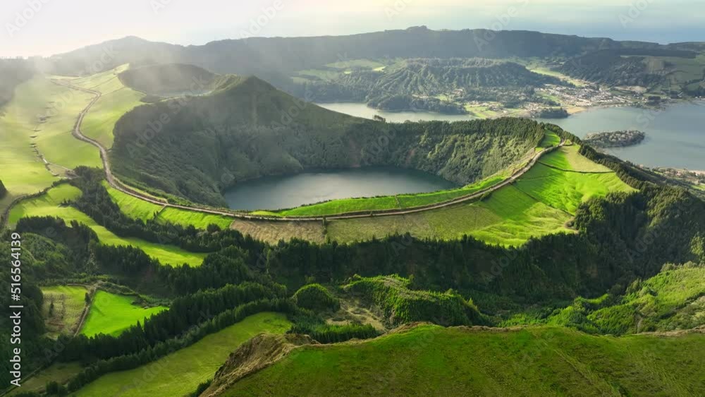 Flying over Lagoa das Sete Cidades lake in sunny day. Sao Miguel Island, Azores, Portugal. Lakes in the craters of extinct volcanoes surrounded by green vegetation
