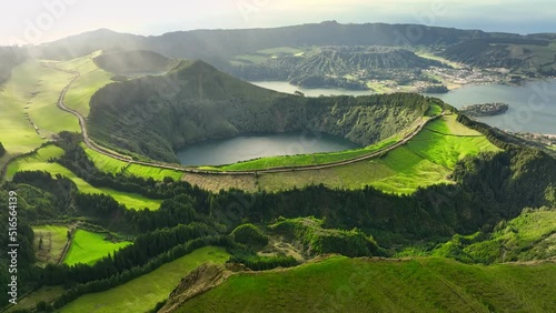 Flying over Lagoa das Sete Cidades lake in sunny day. Sao Miguel Island, Azores, Portugal. Lakes in the craters of extinct volcanoes surrounded by green vegetation