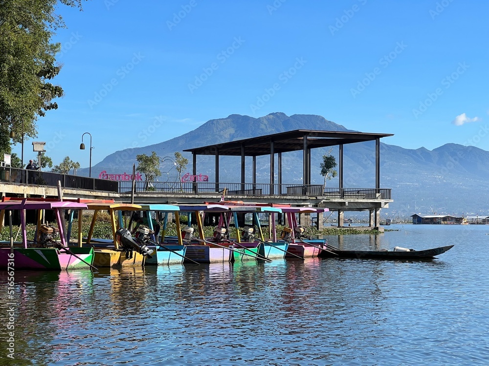 Beautiful Calm Water Reflection Lake and Fisherman working fishing on Boats with Blue Sky and Sunny Weather Clear Horizon Beautiful Calm Water Reflection Lake and Fisherman working fishing on Boats with Blue Sky and Sunny Weather Clear Horizon