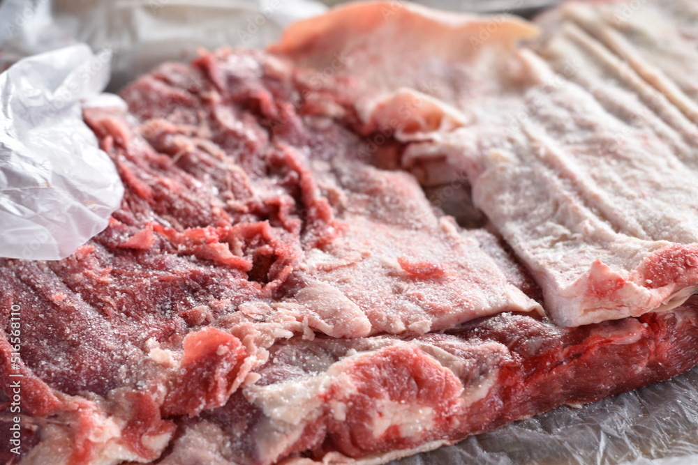 argentinean man salting meat for the barbecue