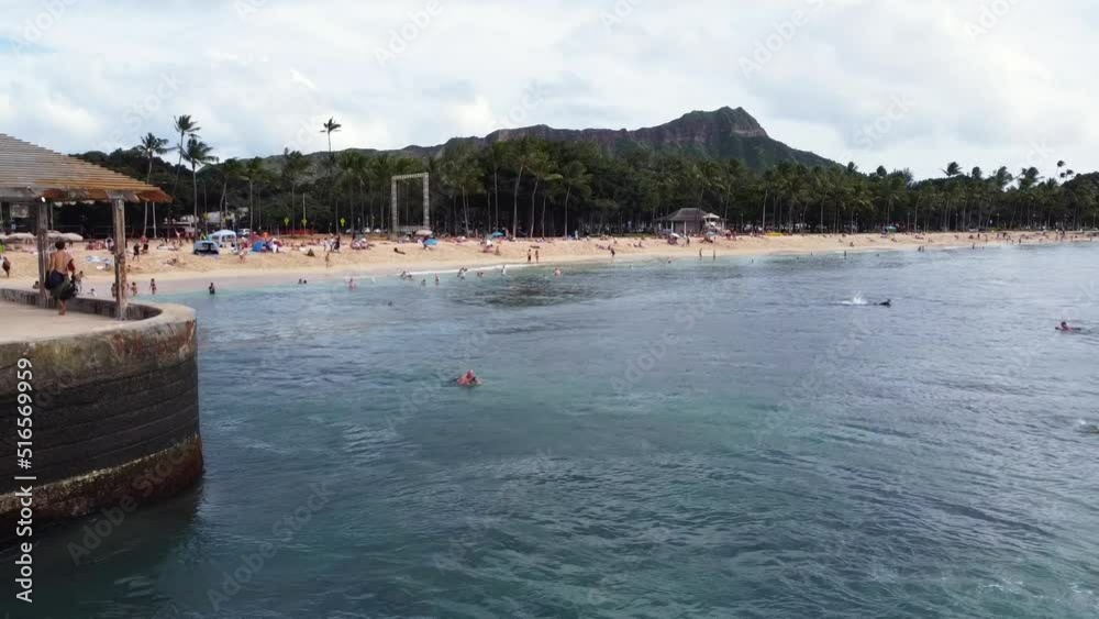 Drone view of surfers and tourists relaxing at the Waikiki Beach Drone view of surfers and tourists relaxing at the Waikiki Beach