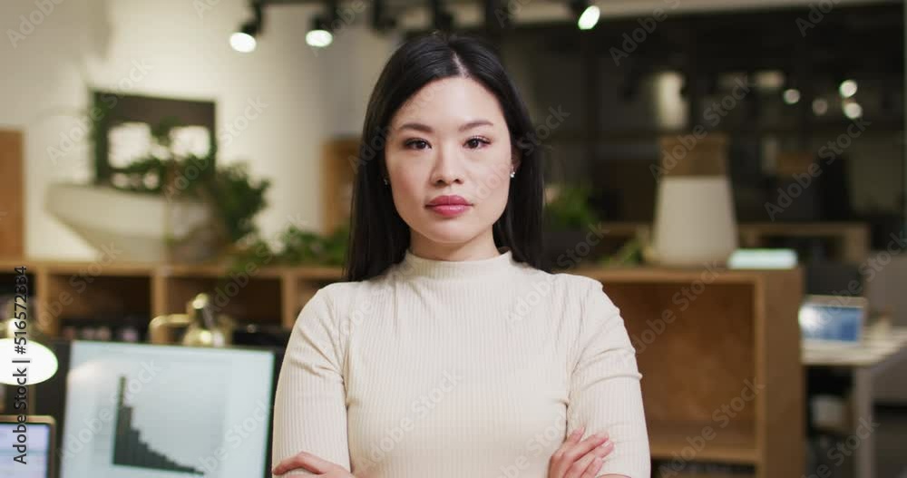 Video of happy asian woman looking at camera in office Video of happy asian woman looking at camera in office