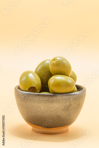 small ceramic bowl with olives of the gordal type, typical appetizer in the Mediterranean