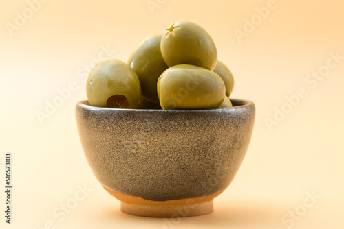 small ceramic bowl with olives of the gordal type, typical appetizer in the Mediterranean photo