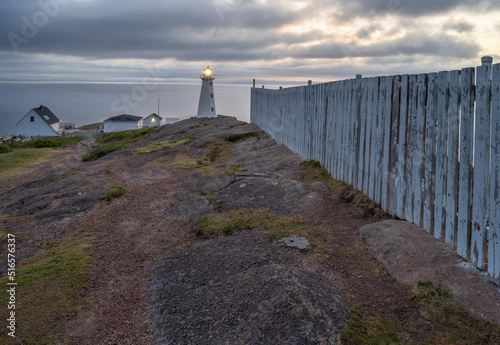 Fog over the lighthouse and fence at Cape Spear