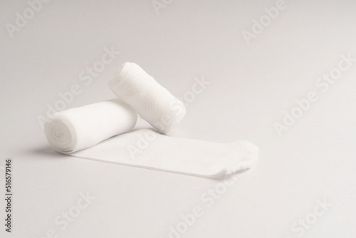 White medical cotton gauze bandage on colorful, Medical bandage of new first aid gauze unrolling