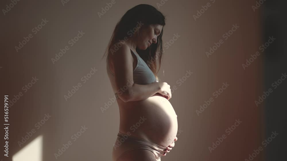 pregnant woman. health pregnancy motherhood procreation concept. close-up belly of a pregnant woman. woman waiting for a newborn baby. pregnant woman holding her belly sun indoors