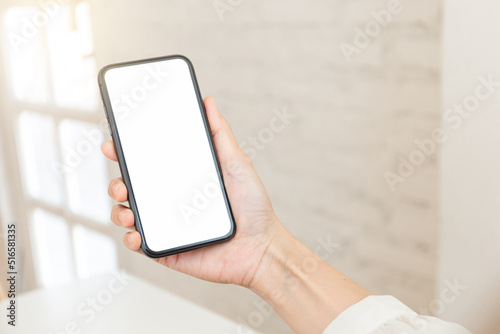 cell phone blank white screen mockup.hand holding texting using mobile on desk at office.background empty space for advertise.work people contact marketing business,technology