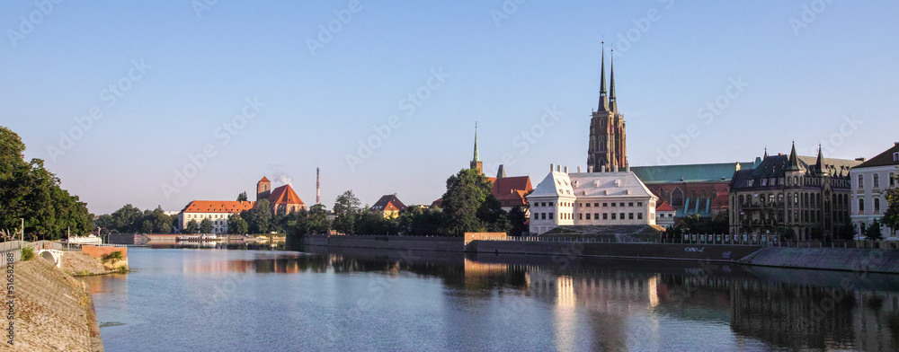 Obraz premium Odra river and tree on Ostrow Tumski in the morning fog. Sunrise over river. Wroclaw.