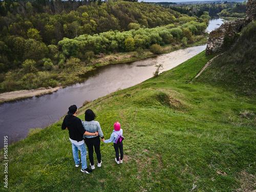 Mother, father daughter enjoys the view on the coast Sluch river photo