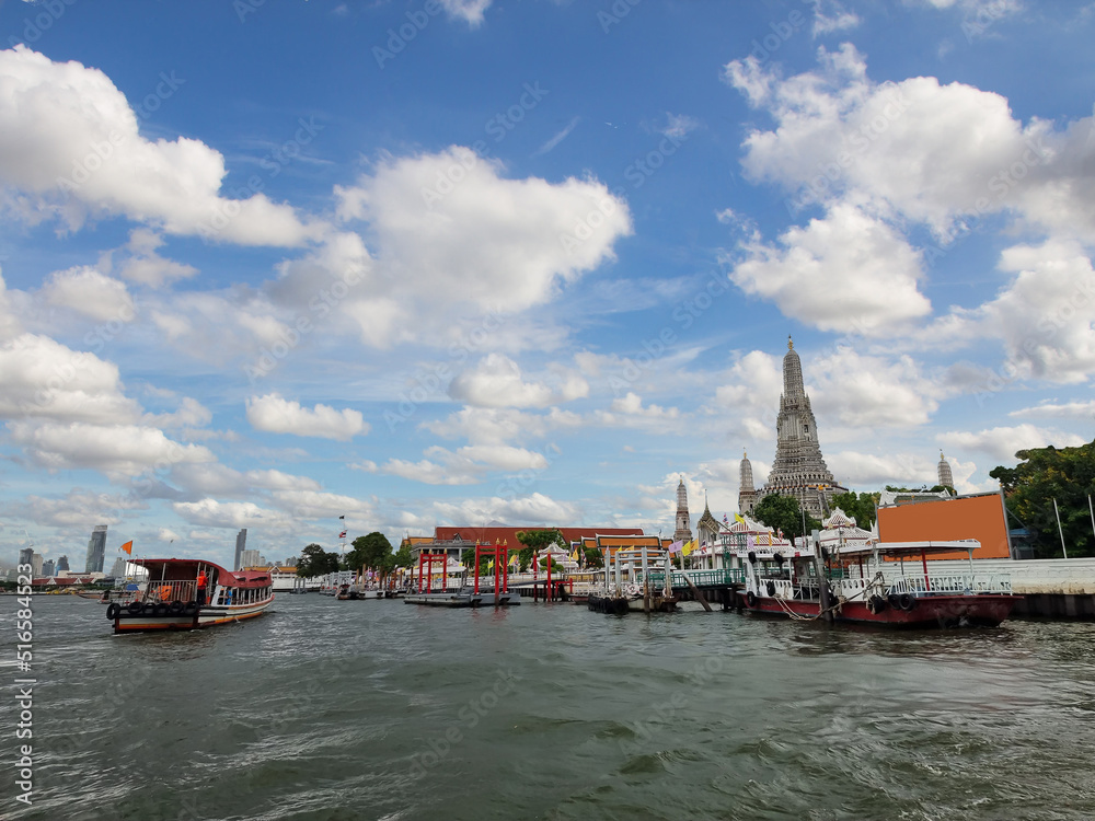 Scenic view of Chao Phraya river. Ferry pier for sightseeing boat tour at Wat Arun temple.
