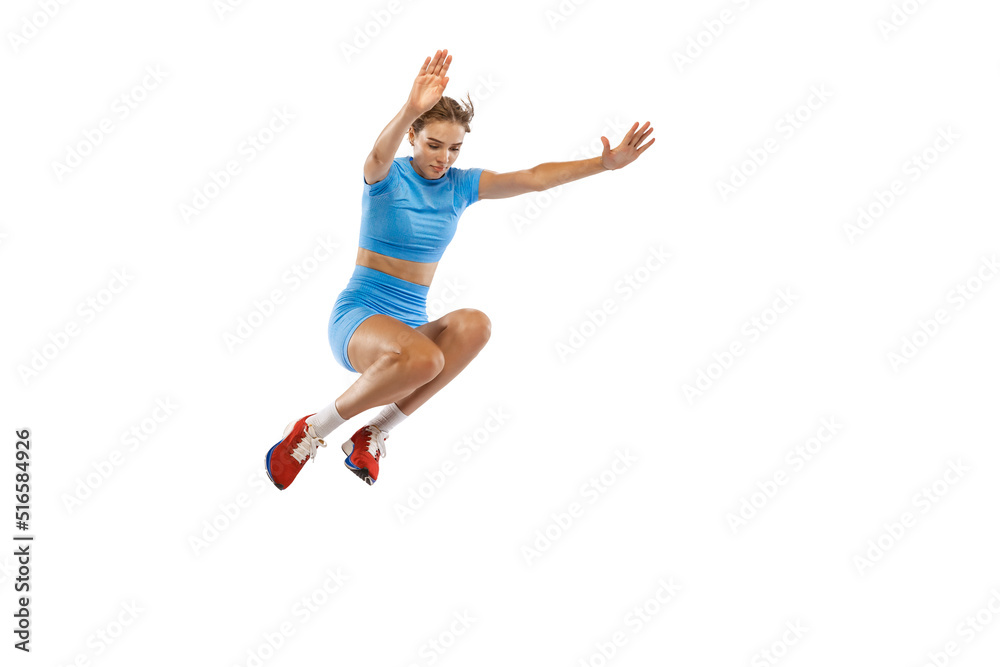 Triple jump technique. Studio shot of female athlete in sports uniform jumping isolated on white background. Concept of sport, action, motion, speed.