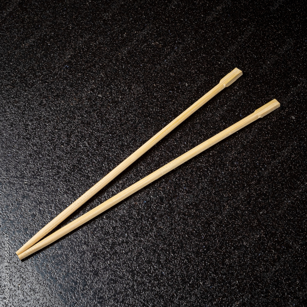 wooden chopsticks on the black background wooden chopsticks on the black background