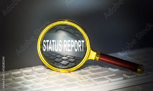 STATUS REPORT word concept on a magnifier on the keyboard photo