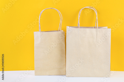 The Vintage brown paper bags on yellow background.