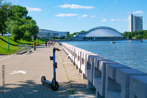 Minsk, Belarus - JUNE 24, 2022 : Vacationers on the Svisloch river in the center of Minsk . Traetskae Pradmestse or Trinity Suburb e historical center of Minsk. photo