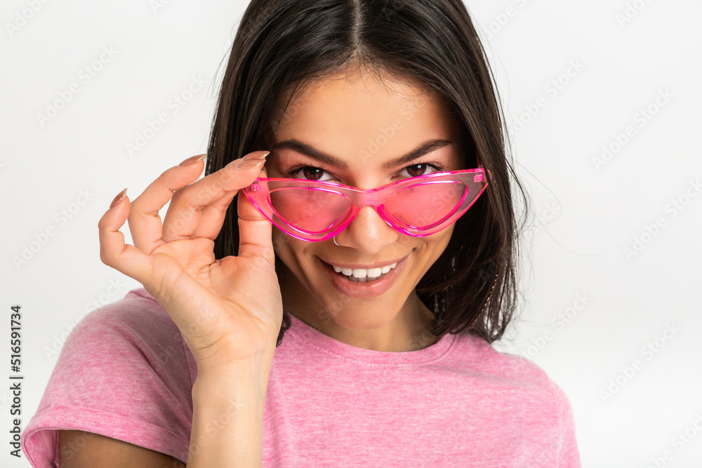 attractive woman in pink t-shirt and sunglasses attractive woman in pink t-shirt and sunglasses