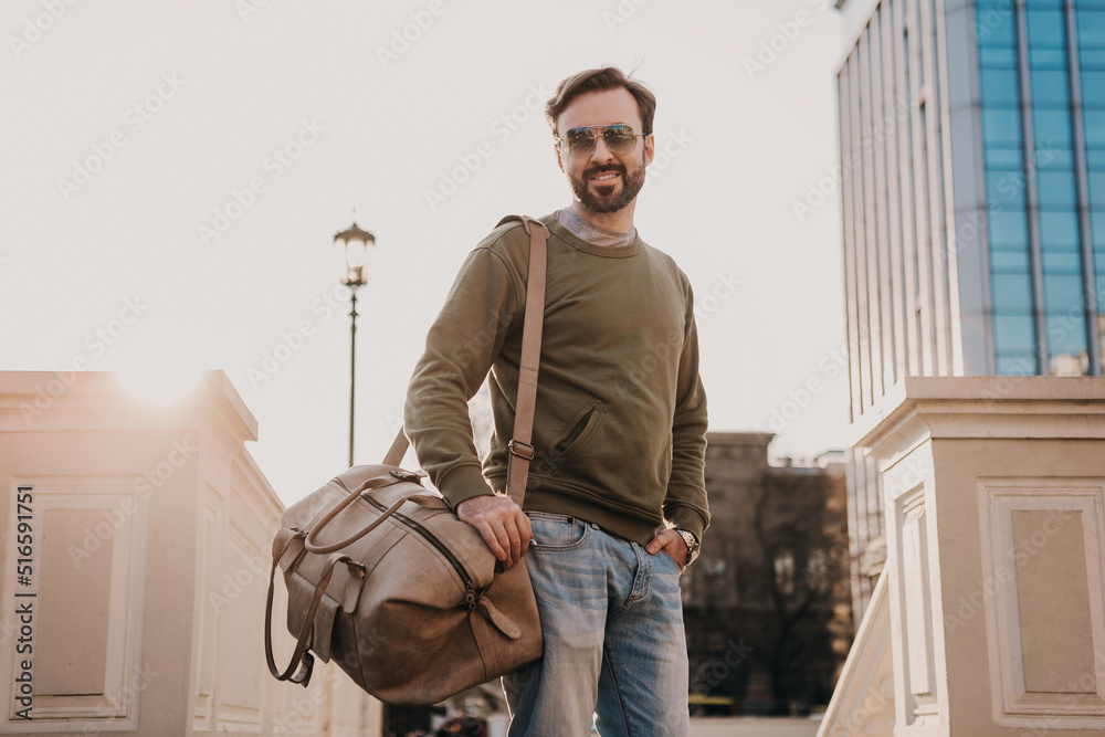hipster man walking in street with bag