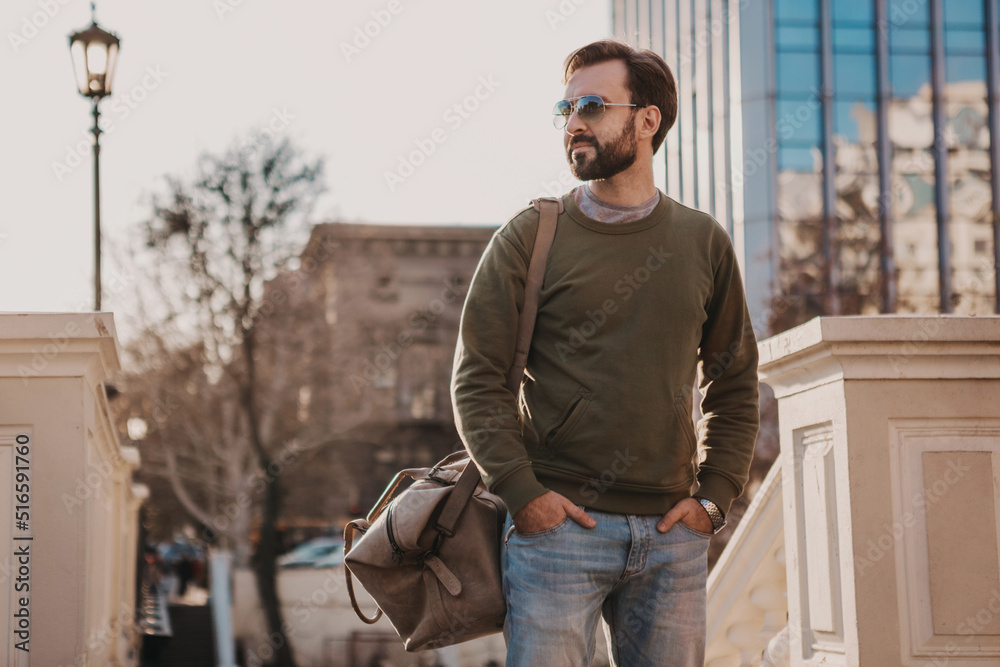 hipster man walking in street with bag hipster man walking in street with bag