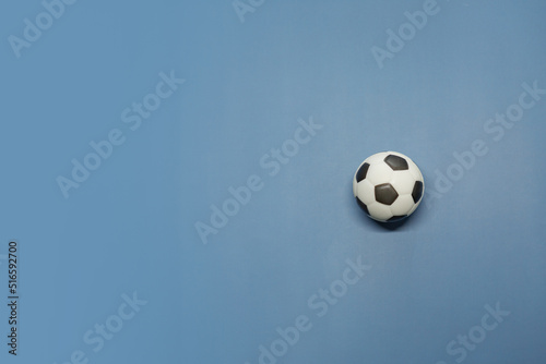 A soccer ball inside on a blue background
