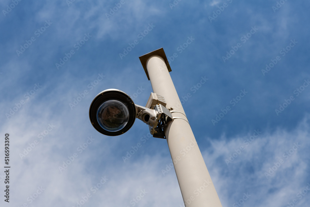 Fototapeta premium Street surveillance camera on a white metal pole