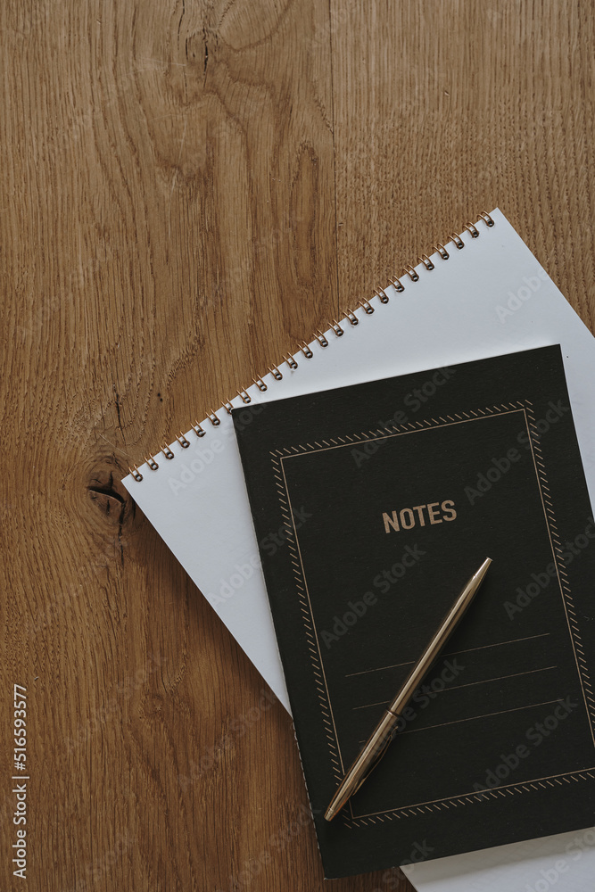 Aesthetic luxury bohemian minimalist concept. Paper sheet notebook, spiral  notebook, pen on wooden table background. Flat lay, top view Stock Photo |  Adobe Stock