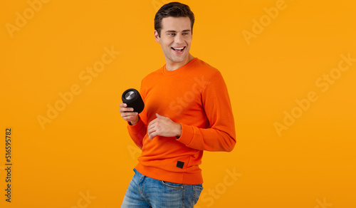 stylish young man holding wireless speaker photo