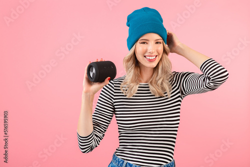 young woman holding music speaker