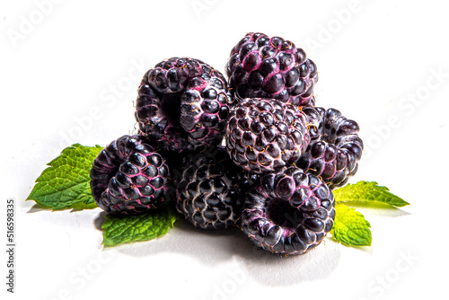 Fresh ripe raw black raspberry, wild sweet berry with mint leaf isolated on white background