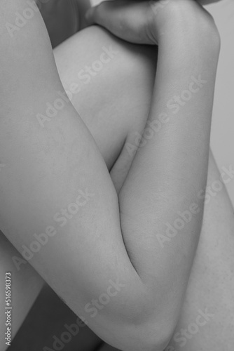 Close-up image of tender female body parts. leg and hand. Black and white photography aesthetics. Body art