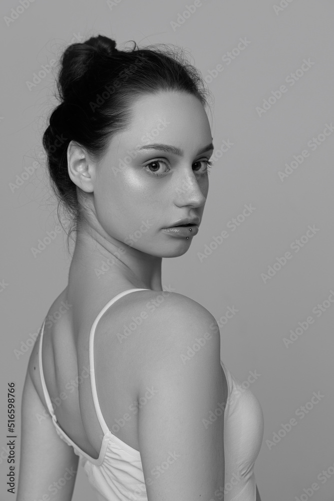 Portrait of young tender girl with no makeup posing, looking at camera. Black and white photography Portrait of young tender girl with no makeup posing, looking at camera. Black and white photography