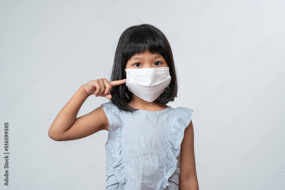 Portrait of Asian girl kid with protective face mask ready for new school year with pandemic restrictions. Concept of kid going back to school and new normal lifestyle Portrait of Asian girl kid with protective face mask ready for new school year with pandemic restrictions. Concept of kid going back to school and new normal lifestyle