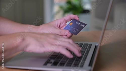 Men hand holding credit card and type payment information on keyboard for order online shopping. Internet technology and Digital market place E-Commerce lifestyle concept, Purchase transaction.