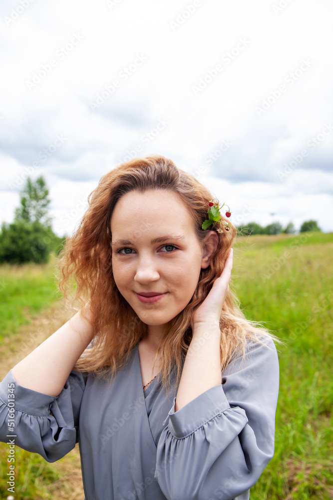 Young girl with wild strawberries in summer day Young girl with wild strawberries in summer day