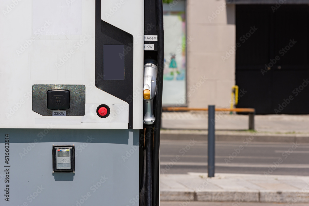 Close up to a charging station with a 22 kw adapter and a contactless payment option Close up to a charging station with a 22 kw adapter and a contactless payment option